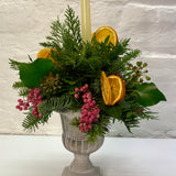 Orange & Berry Christmas Foliage Arrangement in Cement Urn with Candle
