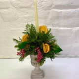 Orange & Berry Christmas Foliage Arrangement in Cement Urn with Candle